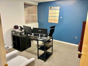 Home office with carpet and baseboards