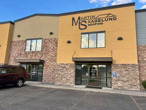 View of commercial location featuring uncovered parking