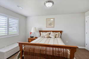 Carpeted bedroom with baseboards