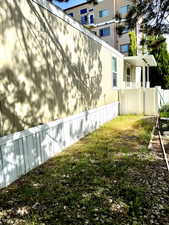 View of side of home with fence