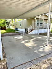 View of patio with a carport and a porch