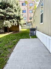 View of patio / terrace with central AC, fence, and an outbuilding