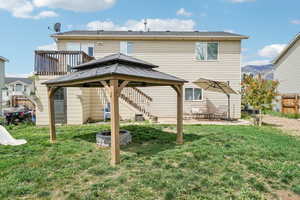 Rear view of house featuring a gazebo and a patio area