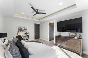 Bedroom featuring a raised ceiling, light wood-style flooring, recessed lighting, baseboards, and ceiling fan