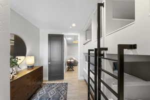 Foyer entrance with light wood finished floors, baseboards, and recessed lighting