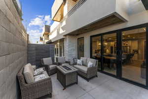 View of patio featuring an outdoor living space with a fire pit