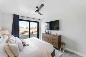 Bedroom with access to outside, baseboards, a ceiling fan, and light wood-style floors