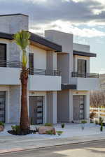 View of building exterior featuring a garage and fence