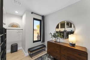Living area featuring light wood-style flooring, baseboards, and recessed lighting