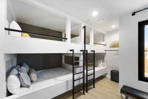Bedroom with wood finished floors and recessed lighting