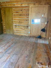 Spare room featuring wood-type flooring