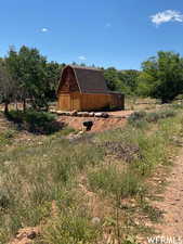 View of yard featuring a barn and an outdoor structure