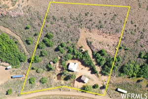 Aerial view of sparsely populated area with property parcel outlined and a desert landscape
