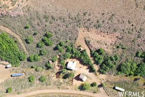Aerial view of property and surrounding area featuring rural landscape and a desert landscape
