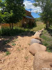 View of yard with fence and an outdoor structure