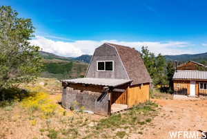 View of barn with a mountain view