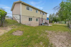 Back of property with a patio and central air condition unit