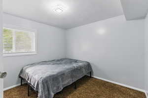 Carpeted bedroom featuring baseboards