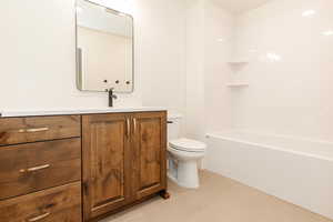 Bathroom featuring toilet, vanity, and tile patterned floors