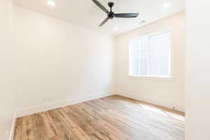 Unfurnished room with a ceiling fan, wood finished floors, baseboards, and recessed lighting
