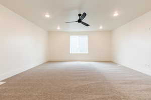 Carpeted spare room with ceiling fan, recessed lighting, and baseboards