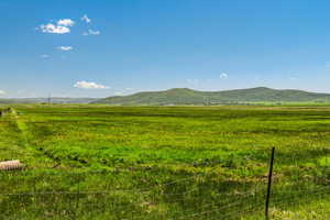 View of mountain backdrop with rural landscape and a pastoral area