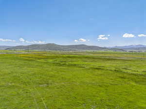 View of mountain backdrop with rural landscape and agricultural land