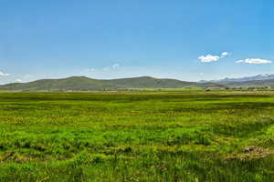 View of mountain backdrop featuring rural landscape and agricultural land