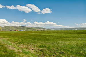 View of mountain backdrop with rural landscape and agricultural land