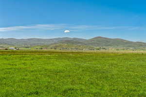 View of mountain backdrop featuring rural landscape and a pastoral area