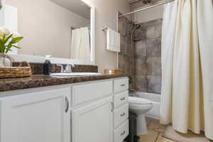 Full bathroom featuring tile patterned floors, vanity, toilet, and shower / bath combination.