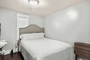 Bedroom featuring wood finished floors.