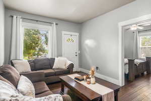 Living area featuring dark wood-style flooring.