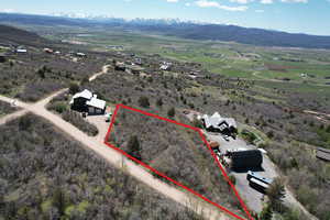 Overview of rural landscape with a mountainous background and property boundaries highlighted
