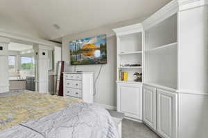 Bedroom featuring baseboards and ensuite bathroom