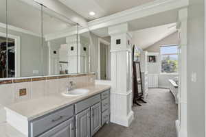 Bathroom featuring backsplash, vanity, recessed lighting, crown molding, and a spacious closet