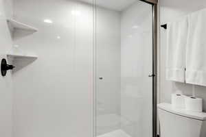 Bathroom with toilet and a shower stall