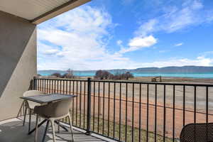 Balcony with a water and mountain view