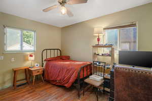 Bedroom with wood finished floors and baseboards