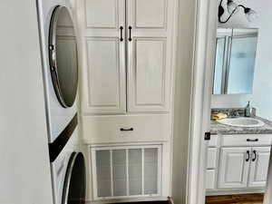 Clothes washing area with estacked washer and dryer and cabinet space