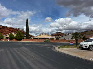 View of asphalt road featuring curbs