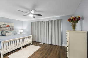 Bedroom with dark wood finished floors and ceiling fan