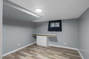 Finished below grade area featuring light wood finished floors and baseboards