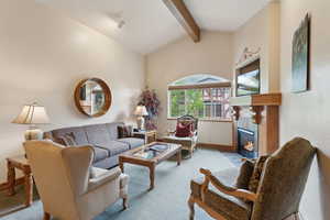 Carpeted living room with a tile fireplace