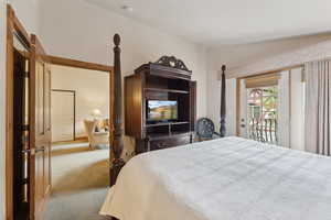 Bedroom with access to exterior and carpet floors