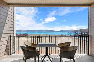 Balcony with a water and mountain view