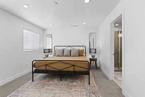 Bedroom featuring carpet, recessed lighting, baseboards, and connected bathroom