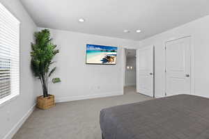 Carpeted bedroom with baseboards and recessed lighting