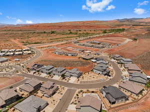 Aerial overview of property's location featuring a mountain backdrop and nearby suburban area