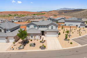 View of front facade with a residential view, a garage, and stucco siding